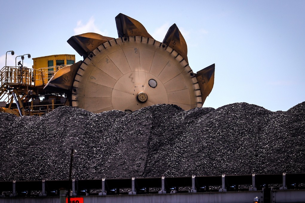 A bucket-wheel reclaimer alongside a pile of coal at the Australian port of Newcastle. Photo: Bloomberg