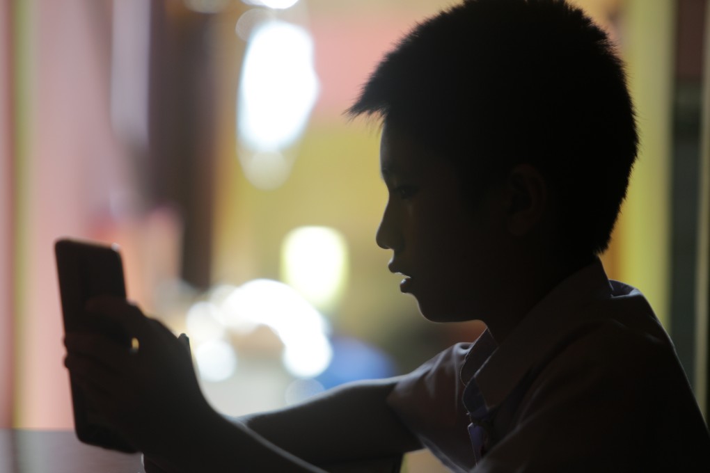 A student uses a mobile phone for online learning during the Covid-19 pandemic in Banda Aceh, Indonesia, last month. Photo: EPA