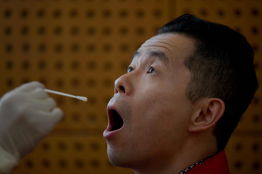 A Chinese citizen undergoes a swab test for the Covid-19 coronavirus. Genscript Biotech has developed a rapid test kit that can detect neutralising antibodies in a person and can be completed in an hour. Photo: AFP
