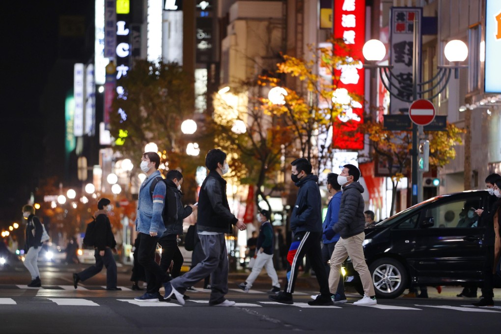 People are seen in the Susukino entertainment district in Sapporo. The Hokkaido government has raised its coronavirus alert and called on restaurants and bars in the district to close at 10pm. Photo: Kyodo