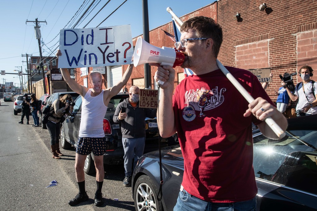 Supporters of US President-Elect Joe Biden and sitting President Donald Trump gather outside a press conference in the back car park of a landscaping company in Philadelphia, Pennsylvania, on November 7. Tensions continue to run high despite the apparent conclusion of the election as Trump persists in claiming fraud despite a lack of evidence. Photo: AFP