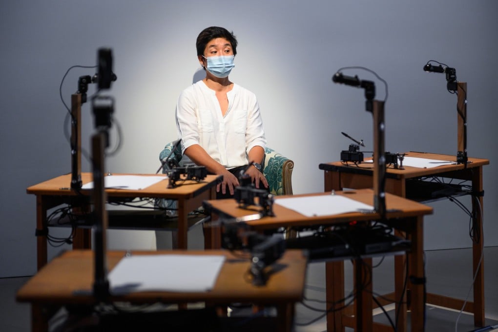 Enid Tsui poses for a portrait by 5RNP, five robots that have been taught to sketch human sitters by artist Patrick Tresset. Photo: ArtisTree