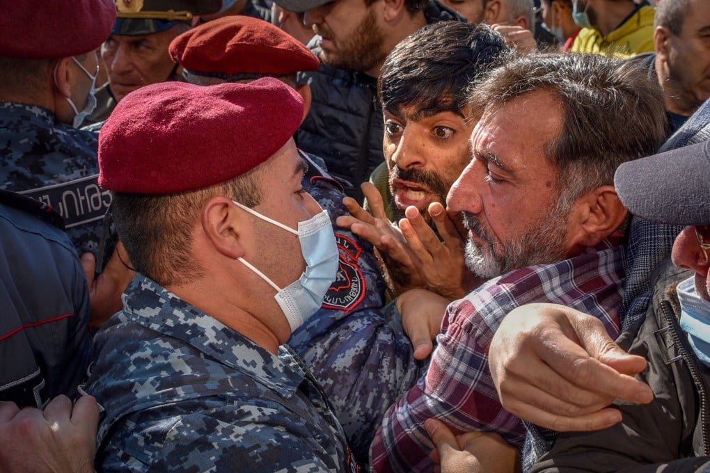 Armenian police officers restrain protesters during a rally outside the government headquarters in Yerevan on Wednesday. Photo: AFP