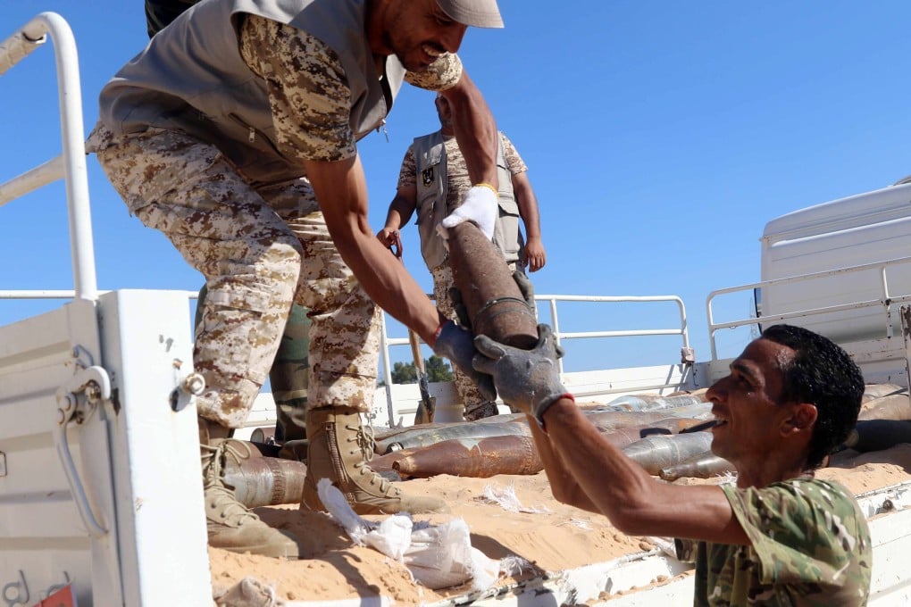 Military engineers of the UN-recognised Libyan Government of National Accord collect mines and explosive devices uncovered in Libya in July. Photo: EPA-EFE