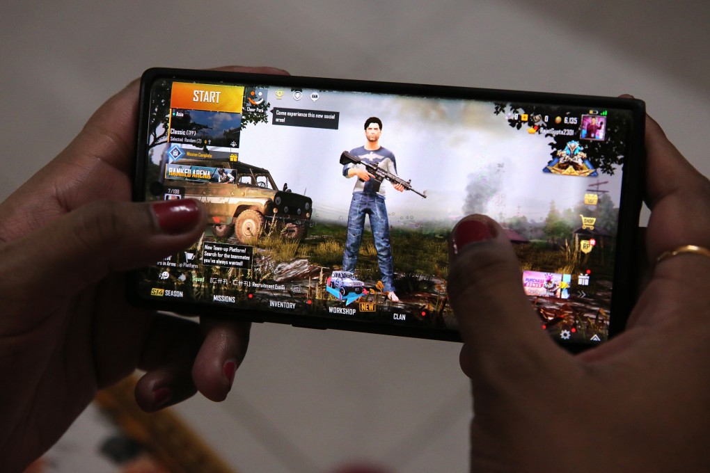 A woman plays PUBG Mobile on her smartphone in New Delhi on September 2. Photo: EPA-EFE