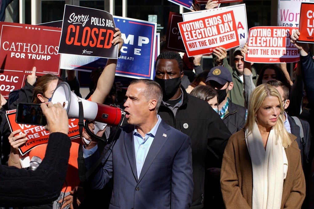 Trump campaign adviser Corey Lewandowski (centre), with former Florida attorney general Pam Bondi (right), speaks outside the Pennsylvania Convention Centre on November 5. Photo: AFP