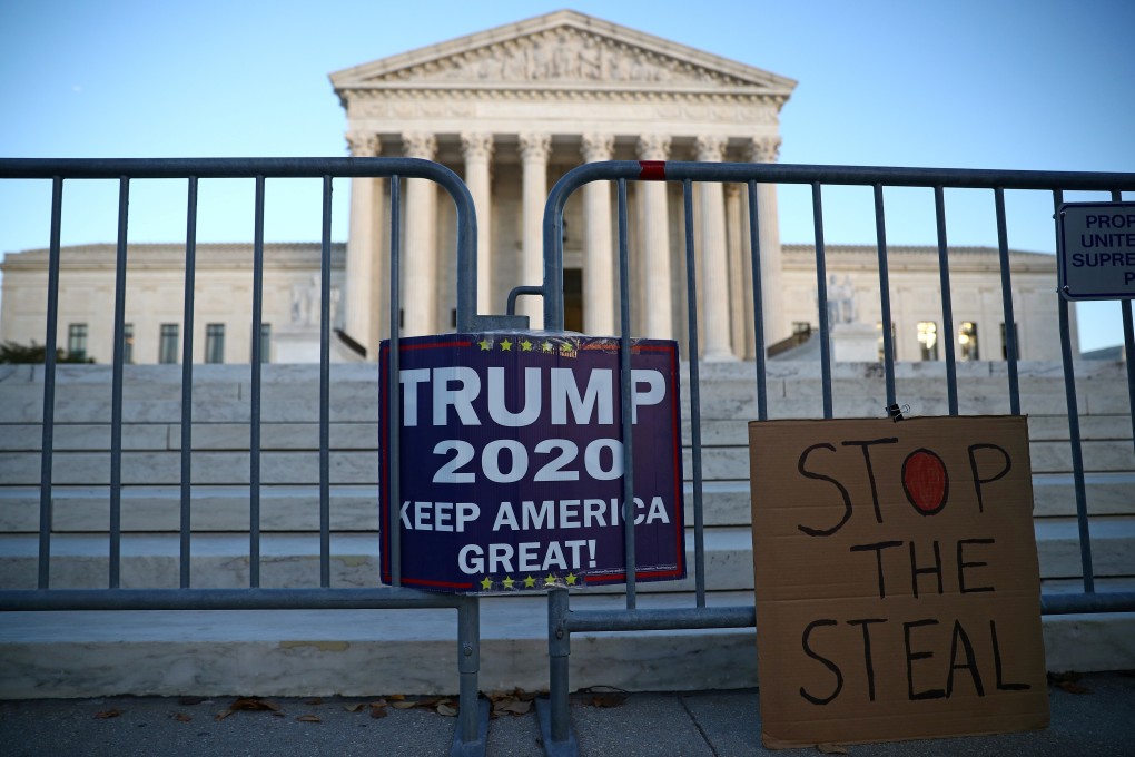 Signs put up by supporters of US President Donald Trump hang outside the Supreme Court building in Washington on November 10. Photo: Reuters