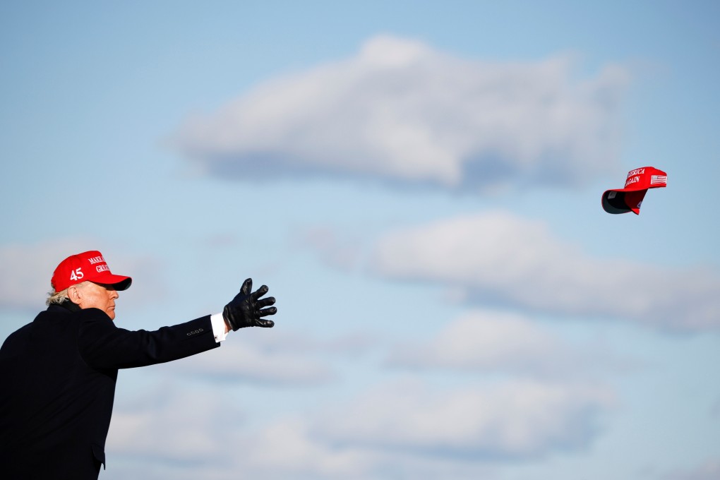 US President Donald Trump tosses a “Make America Great Again” cap during a campaign rally at Wilkes-Barre Scranton International Airport in Avoca, Pennsylvania, on November 2. Would-be autocrats in liberal democracies, like Trump, cannot disseminate nationalist propaganda nearly as efficiently or uniformly as Beijing. Photo: Reuters