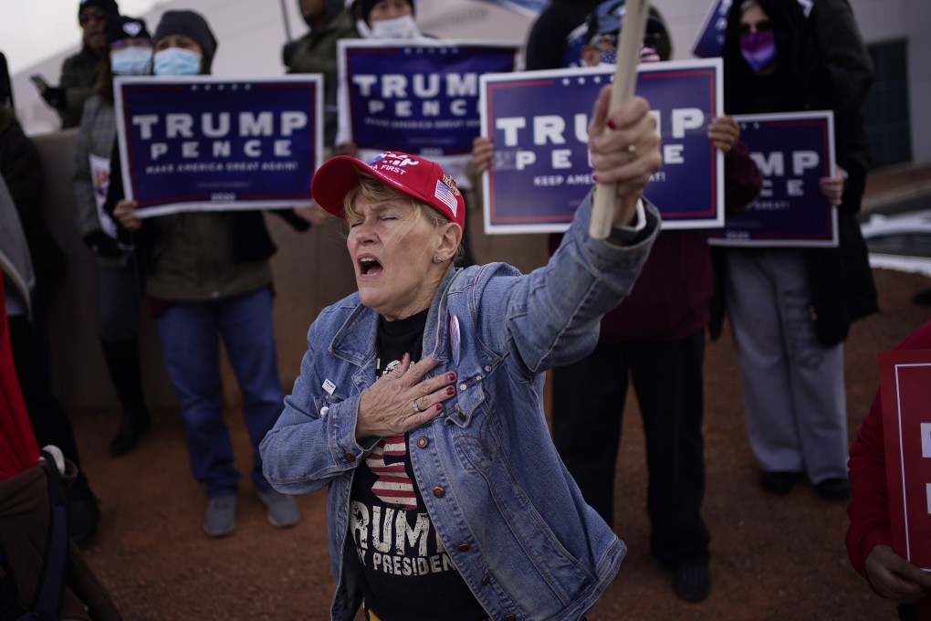 A supporter of US President Donald Trump holds her hand over her heart during a protest of the election outside of the Clark County Election Department in Las Vegas on November 8. Photo: AP