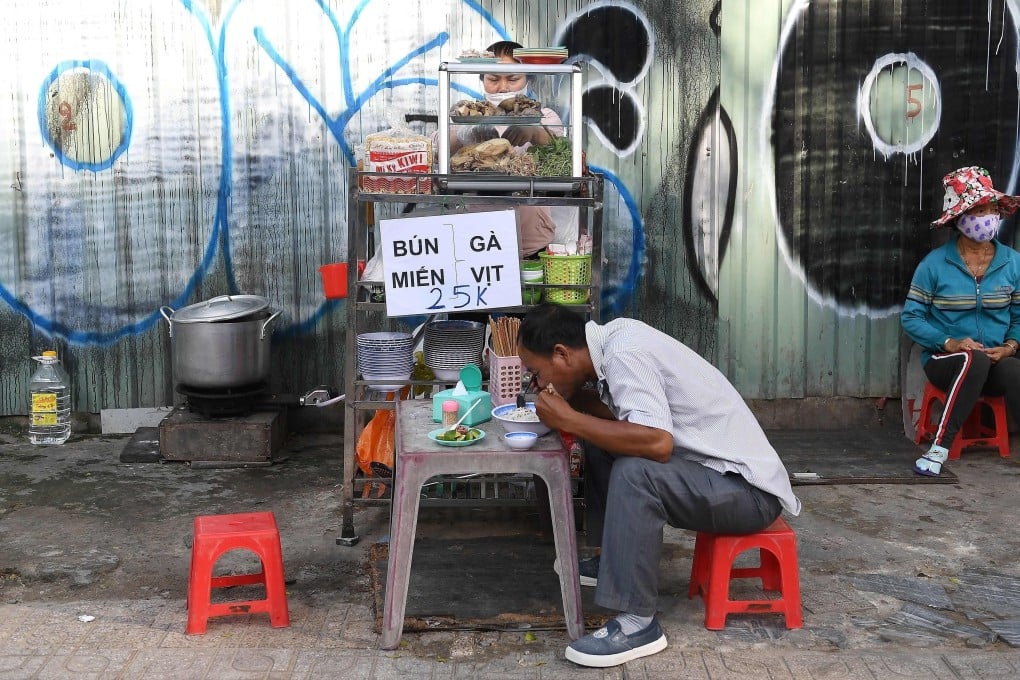 A man eats a bowl of noodle soup from a street food vendor in Ho Chi Minh City. Many Vietnamese are increasingly concerned about what goes into the food they eat, after a series of food safety scandals. Photo: AFP