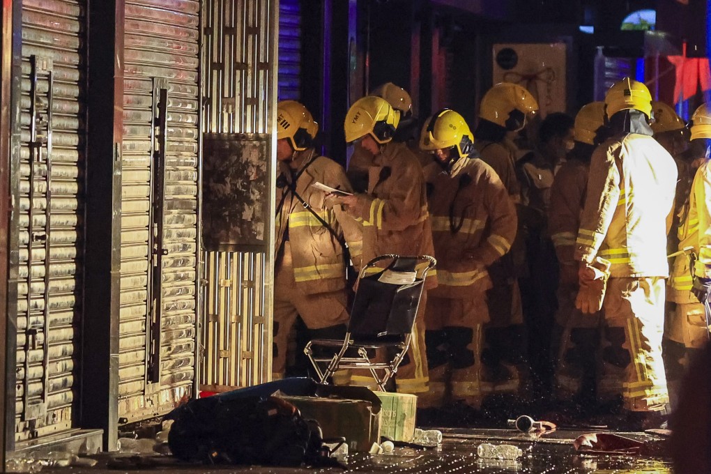 Firefighters investigate the scene of a deadly fire which broke out in a residential building in Yau Ma Tei on November 15. Photo: May Tse