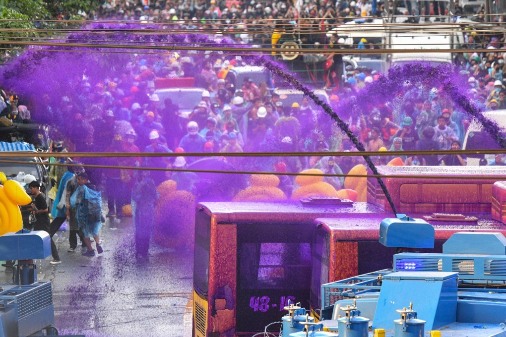 Police use a water cannon with chemical-laced water to disperse pro-democracy protesters in Bangkok. Photo: AFP