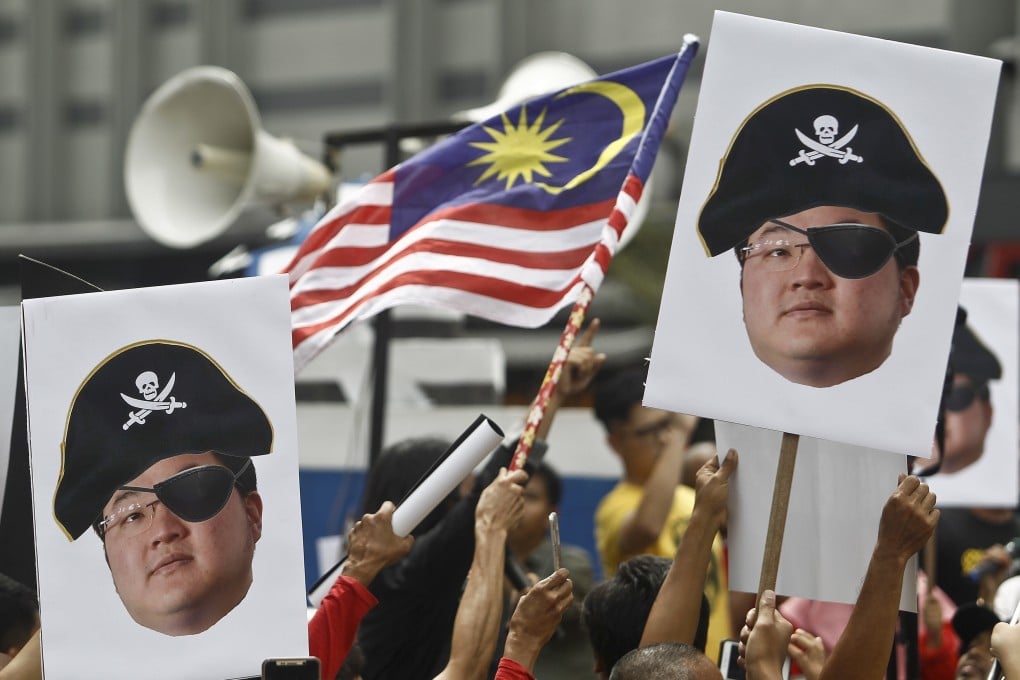 Protesters hold illustrations of fugitive financier Jho Low during a 2018 protest in Kuala Lumpur. Photo: AP