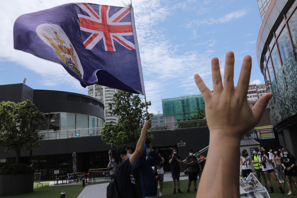 Anti-government protesters waving the Hong Kong colonial flag during a protest in June at Metroplaza, Kwai Chung. Photo: SCMP / K. Y. Cheng