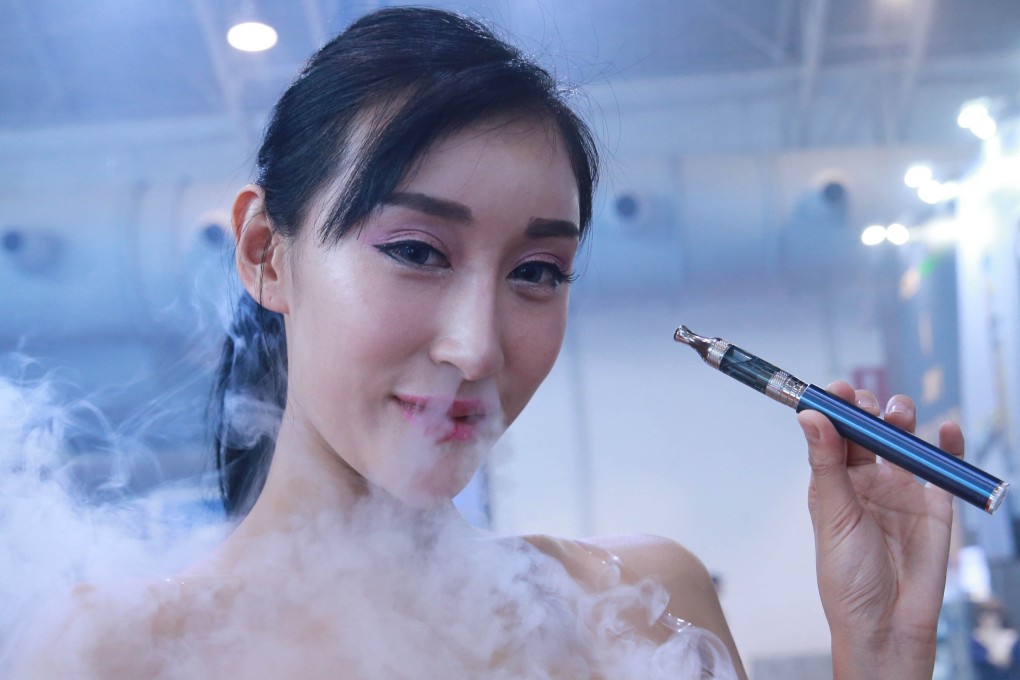 A model smokes an electronic cigarette during the Beijing International Vapor Distribution Alliance Expo. In a recent study, people who vaped showed more changes in the genes that fight off viruses than people who do not smoke. Photo: Getty Images