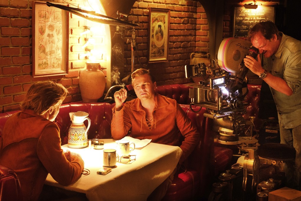 Quentin Tarantino with Leonardo DiCaprio and Brad during the filming of Once Upon a Time … in Hollywood. The Oscar-winning director has a two-book deal with Harper, beginning with a novelisation of the film that is scheduled for next summer. Photo: Andrew Cooper/Sony/AP