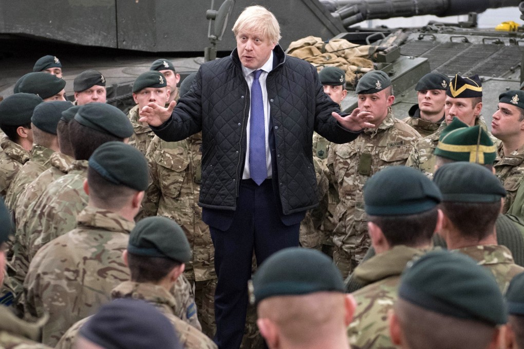 Britain's Prime Minister Boris Johnson speaks with troops. File photo: AFP