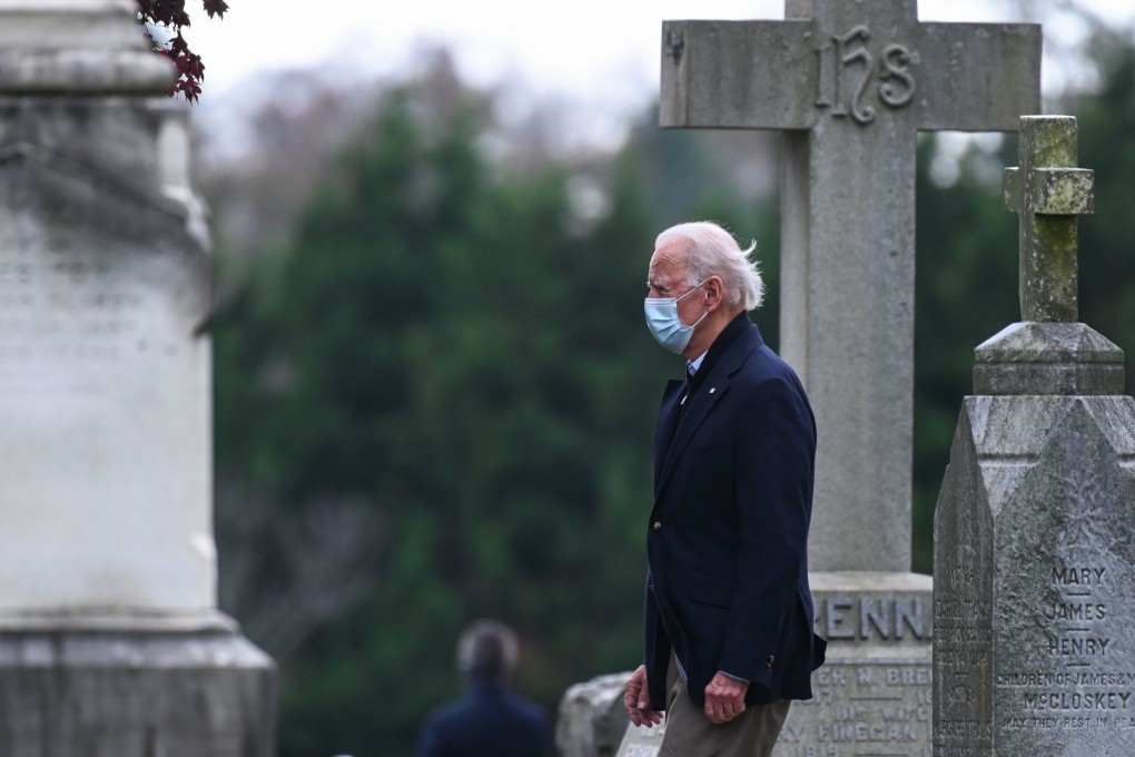 US President-elect Joe Biden walks past tombstones after leaving the St Joseph on the Brandywine Catholic Church after attending Mass in Wilmington, Delaware, on Sunday. Photo: AFP