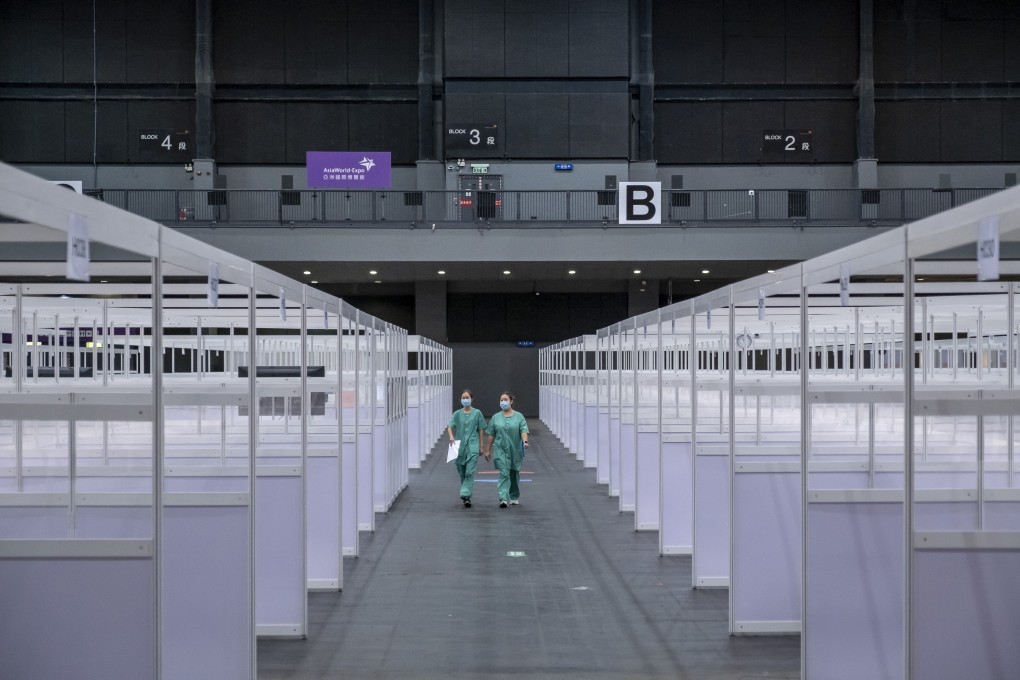 Health workers walk through a quarantine facility during a media tour of a temporary community treatment facility for Covid-19 patients at the AsiaWorld-Expo in Hong Kong on August 1. Photo: Bloomberg