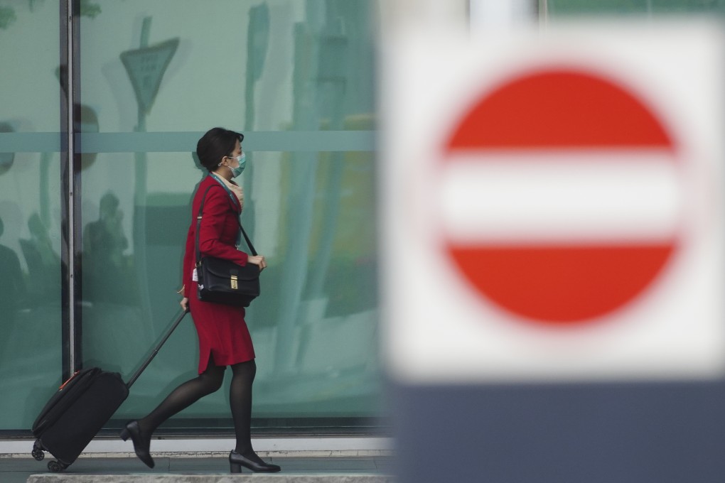 A Cathay Pacific employee wheels her luggage towards an entrance to the company’s headquarters in Chek Lap Kok on October 22. Photo: Sam Tsang