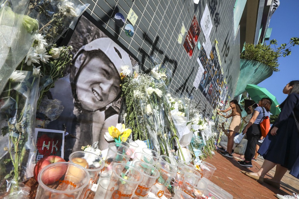 Flowers were laid at the Sheung Tak Estate car park, where student Alex Chow was found with serious injuries before his death a few days later. Photo: Felix Wong