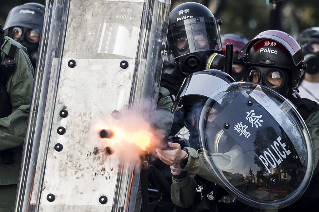 Riot police fire projectiles against protesters in the Sha Tin district of Hong Kong on October 1, 2019. Photo: AFP