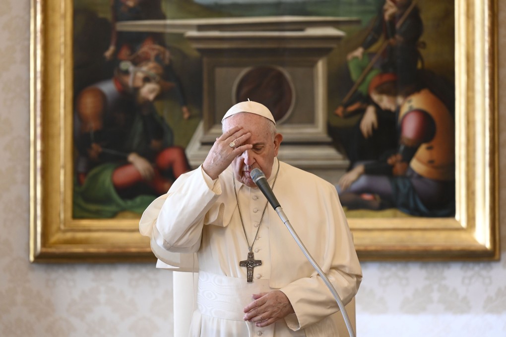 Pope Francis crosses himself during an audience from the library of the apostolic palace in The Vatican on Wednesday. Photo: Vatican Media handout via AFP