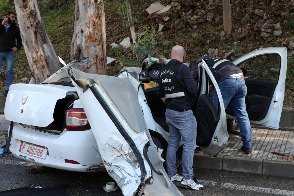 Police inspect the damaged car in Hadath, Lebanon. Photo: Reuters