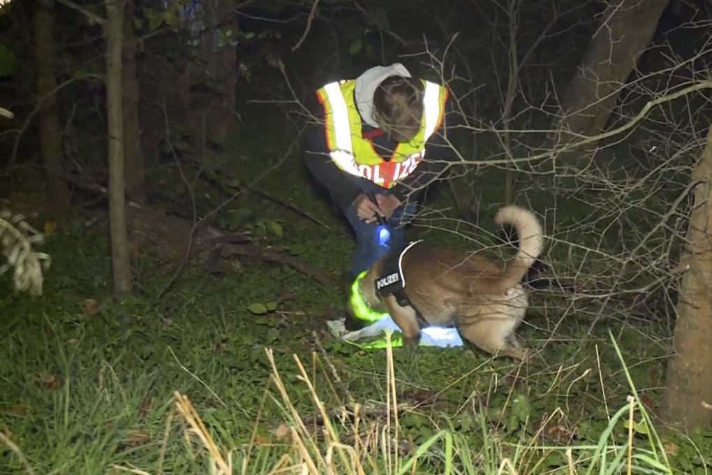 A policeman with a tracker dog searches for a missing man in Berlin on November 9. Photo: Telenewsnetwork/dpa via AP