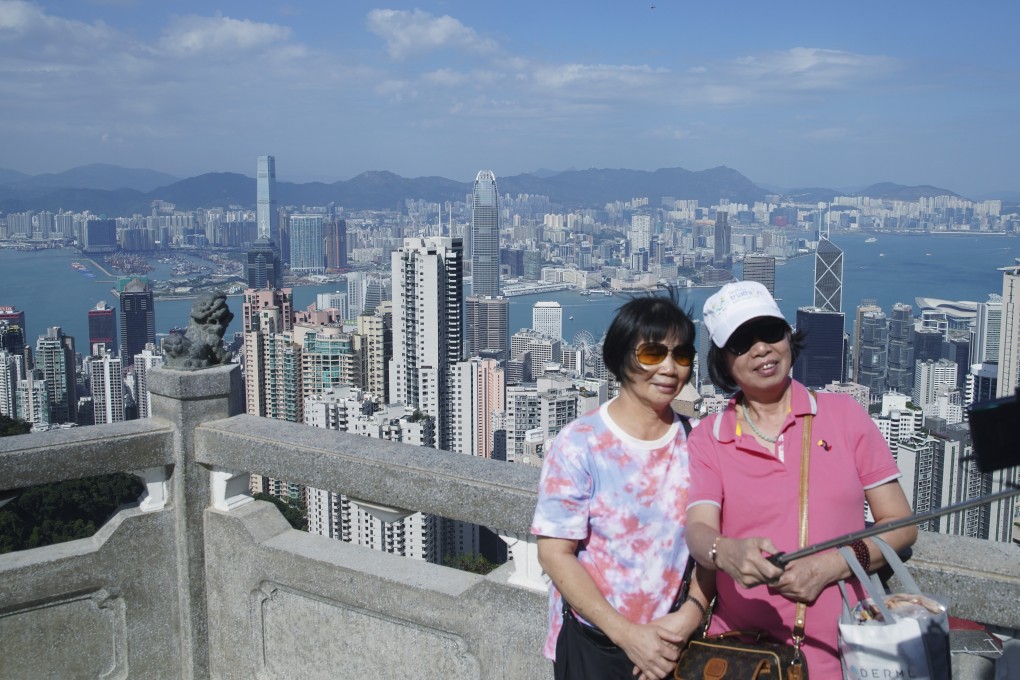People admire the Hong Kong skyline at the Peak. Photo: Winson Wong