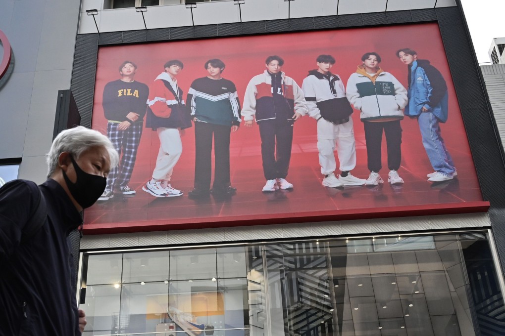 K-pop power is prevalent in China but the industry is at the mercy of China-South Korea relations. Here, a man walks past a poster showing K-pop group BTS members at a shopping district in Seoul on October 15, 2020, around the time Chinese netizens became enraged by singer RM’s comments about the Korean war. Photo: AFP