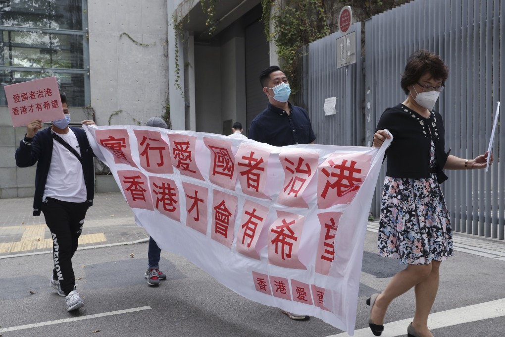 Pro-Beijing groups show support to the move to disqualify four pan-democratic lawmakers, outside Tamar. Photo: SCMP/ Edmond So