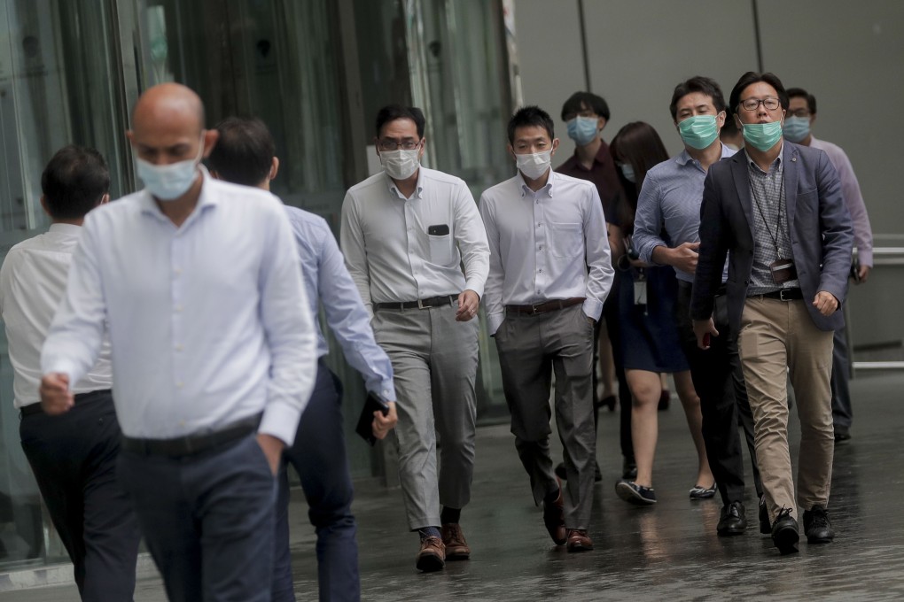 Office workers walk through Singapore’s financial district amid the coronavirus pandemic in September. Photo: EPA
