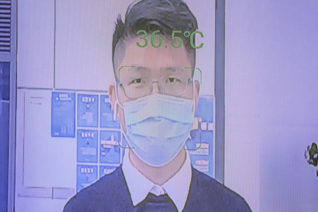 A man has his temperature measured at the entrance to an office building by an AI computer called ‘Smart AI Epidemic Prevention’ made by the company SenseTime, in Shenzhen, China in March 2020. Photo: EPA-EFE