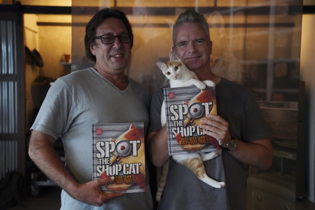 Hong Kong-based Australian illustrator Stephen Case (left) and Dutch photographer Marcel Heijnen show off their new book Spot the Shop Cat in Tsing Yi, Hong Kong. Photo: Winson Wong