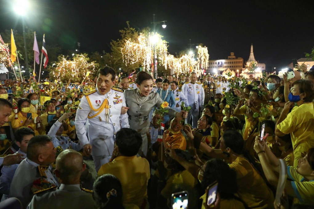 Thai King Maha Vajiralongkorn and Queen Suthida greet supporters outside the Grand Palace in Bangkok after presiding over a religious ceremony at a Buddhist temple inside the palace earlier this month. Photo: AFP