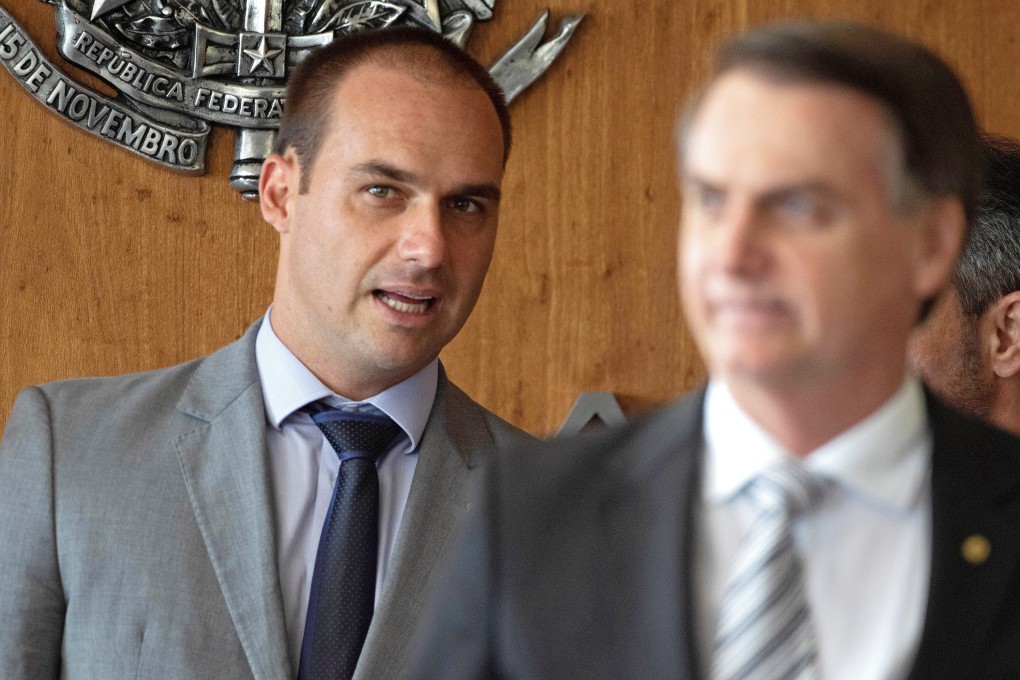 Brazilian congressman Eduardo Bolsonaro (left, behind his father, President Jair Bolsonaro) deleted his tweet accusing Huawei of espionage but has criticised China in other statements. Photo: EPA-EFE