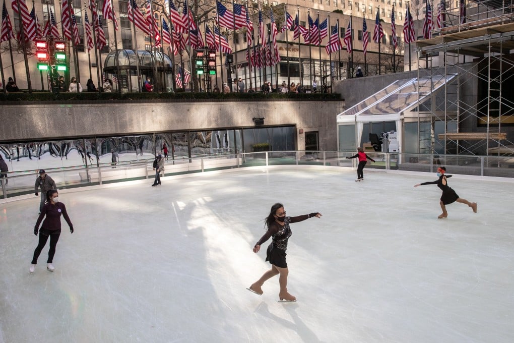 People wearing protective masks skate at Rockefeller Centre in New York City on Saturday as the spread of the Covid-19 continues, in New York City. Photo: Reuters