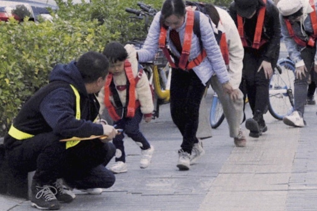 Artist Deng Yufeng (left) took a group of people down a street in Beijing, China, in an art piece that involved trying to not get caught on any surveillance camera. Photo: Deng Yufeng