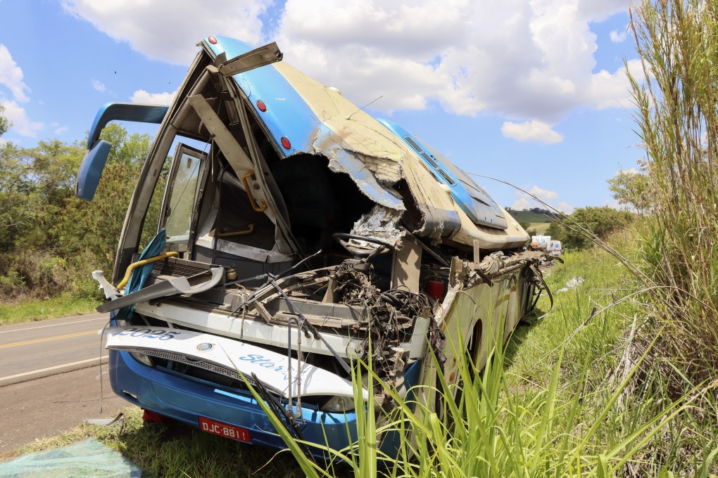 The wreckage of a bus that collided with a truck is seen by the road in Brazil on Wednesday. Photo: AP