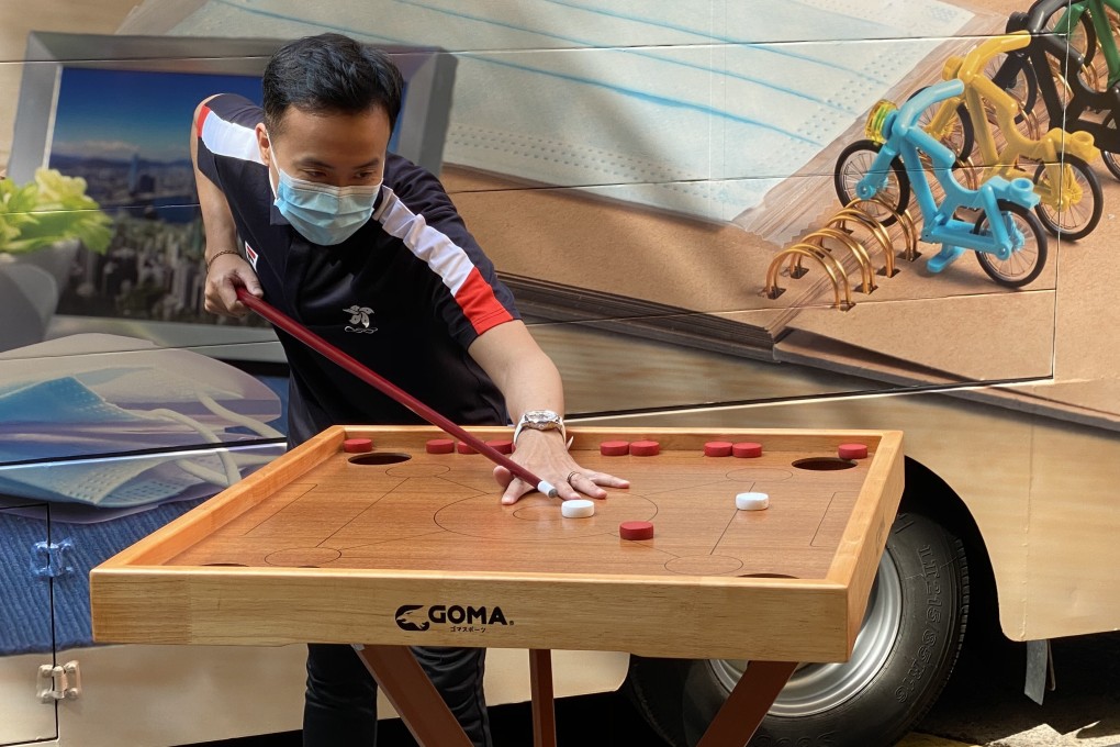 Marco Fu employs his snooker skills to play Chinese carom during a promotional event for the 2020 Hong Kong Festival of Sport. Photo: Chan Kin-wa