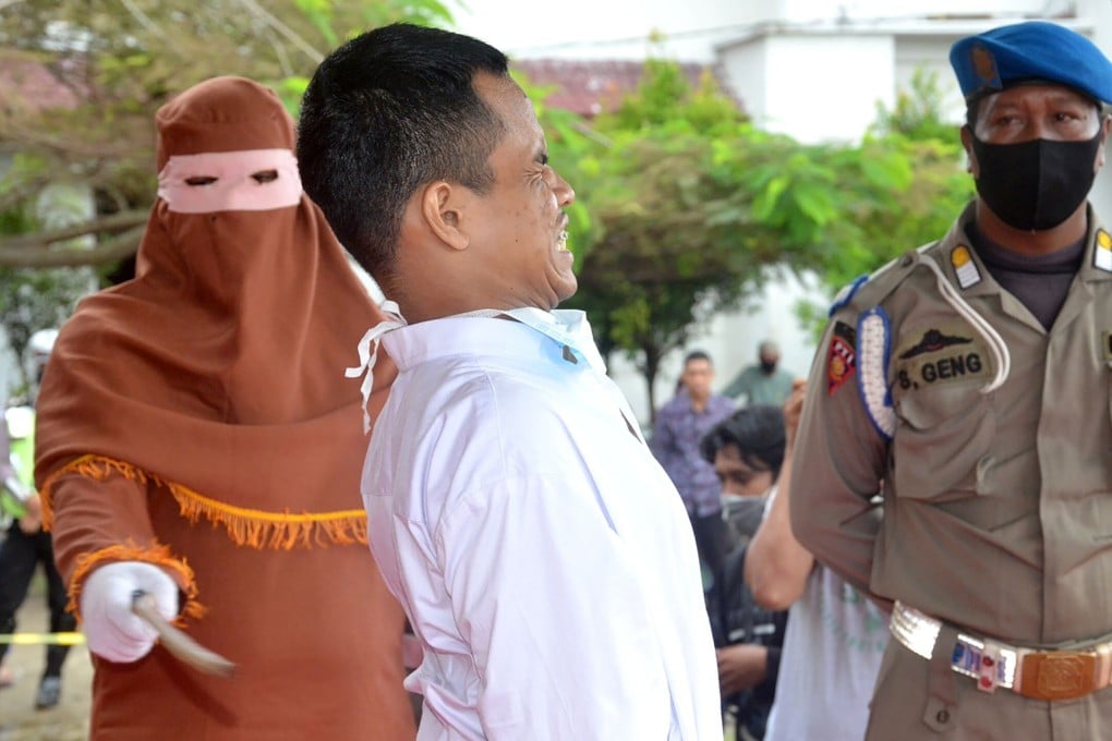 A man is publicly flogged by a member of the sharia police on November 26, 2020. Photo: AFP
