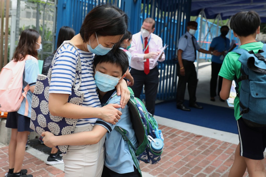 A mother hugs her son goodbye outside a school in Tai Kok Tsui on the first day back to school after coronavirus closures on May 29. Many Hong Kong parents are anxious about a suspension of face-to-face teaching once again now that the city has entered the fourth wave of Covid-19. Photo: Nora Tam