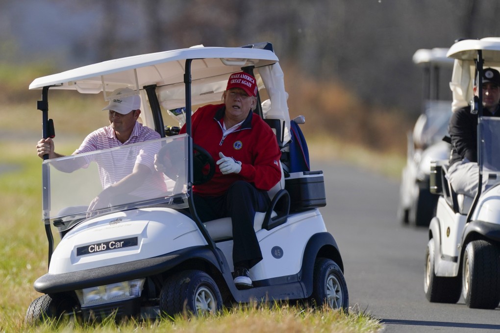 US President Donald Trump gets out of a golf cart at Trump National Golf Club in Sterling, Virginia, on Thursday. Photo: AP