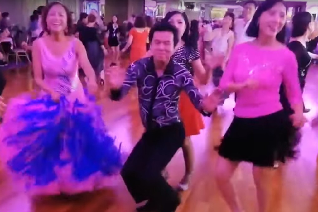 A screen grab of a video posted online shows a group of people dancing without face masks at Betterment Banquet Hall in Mei Foo. Source: Handout