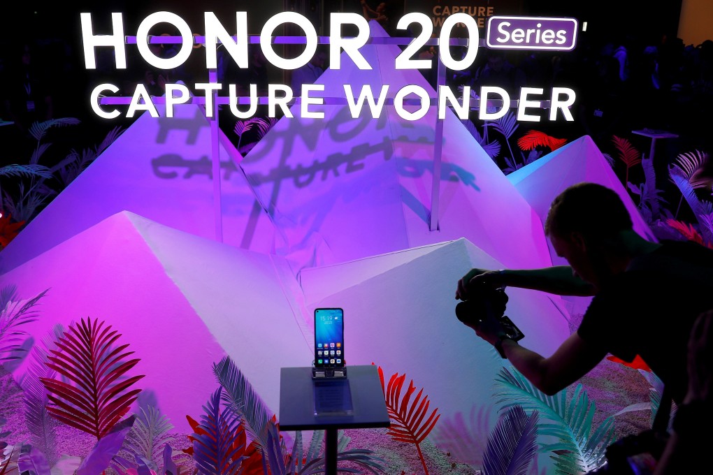 A visitor to the launch of Huawei’s Honor 20 range of smartphones photographs the product at an event in London in May 2019. Photo: Reuters
