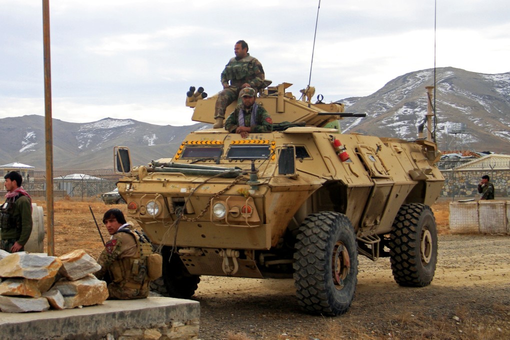 Afghan soldiers outside a military compound after a car bomb blast on the outskirts of Ghazni city. Photo: Reuters