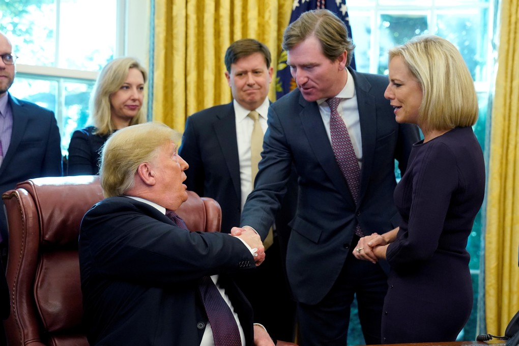 US President Donald Trump shakes hands with Chris Krebs at the White House in 2018. Photo: Reuters