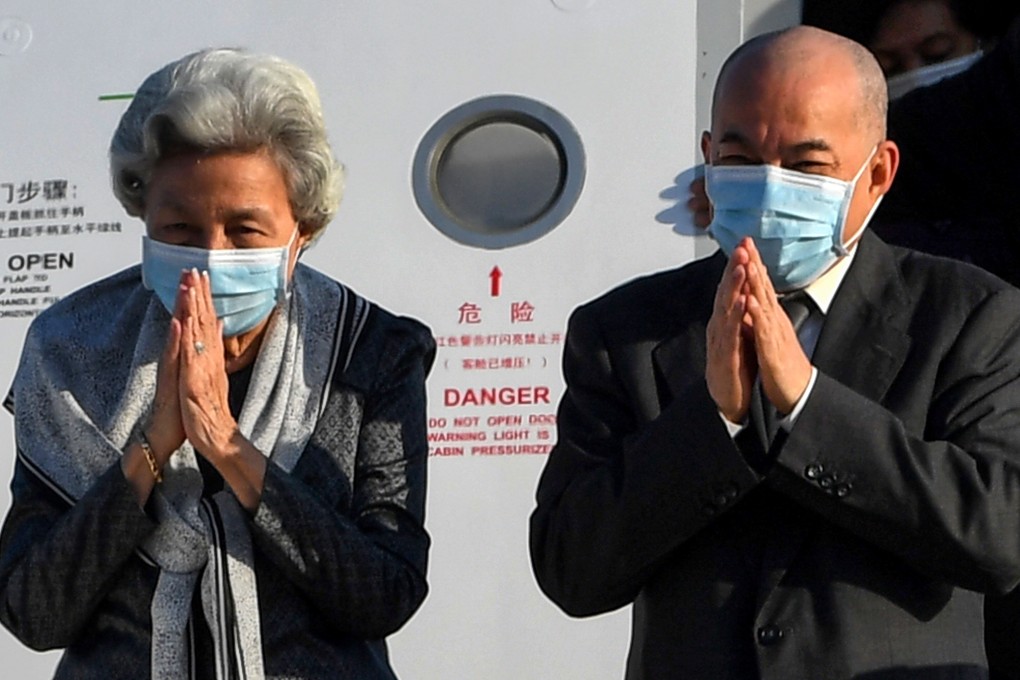 Cambodian King Norodom Sihamoni and queen mother Norodom Monineath Sihanouk greet people after arriving back in Cambodia after their recent trip to China, where they received a health check-up. Photo: AFP