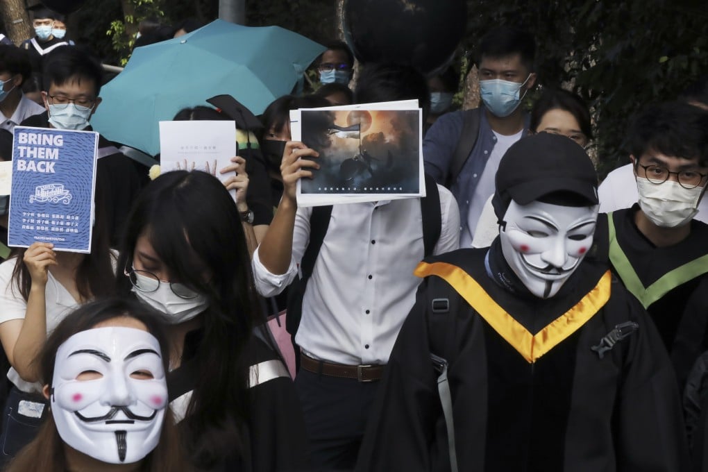 Graduates of the Chinese University of Hong Kong (CUHK) wearing graduation gowns and holding black balloons march from the statue of the Goddess of Democracy outside University Station to the University Mall on CUHK campus, calling public attention of the 12 Hongkongers being detained in the, while the university holds an online graduation ceremony due to the Covid-19 pandemic, November 19, 2020. Photo: K. Y. Cheng